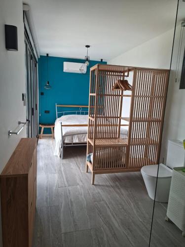 a room with a bedroom with a bed and blue walls at Eco Hideaway in Anoyira