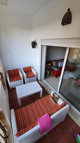 a view of a living room with a couch and chairs at Studio with private beach Folla Residence in Akouda