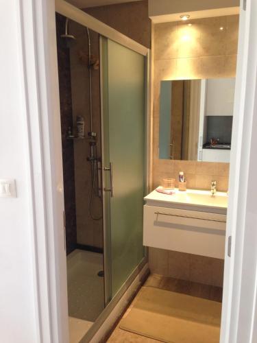 a bathroom with a shower and a sink at Studio with private beach Folla Residence in Akouda