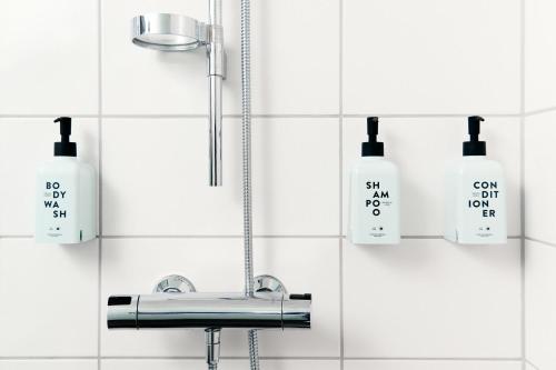 a bathroom with a sink and two soap bottles at Scandic Ruoholahti in Helsinki