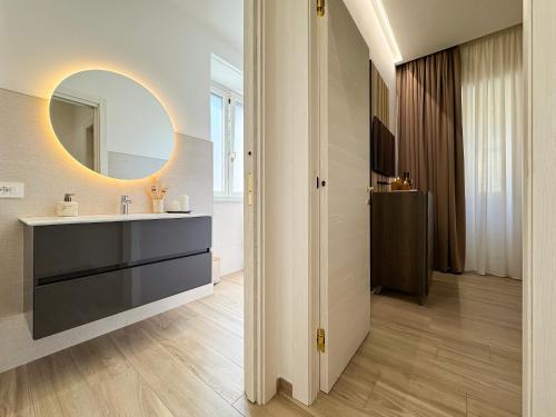 a bathroom with a sink and a mirror at Dimora Alfinito in Salerno