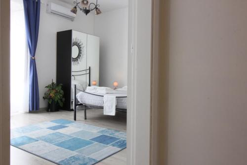 a white room with a bed and a mirror at Al Borghetto in Piazza Armerina