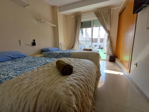 two beds in a hotel room with towels on them at ÁTICO HOME y Garaje, Algemesi Home in Algemesí
