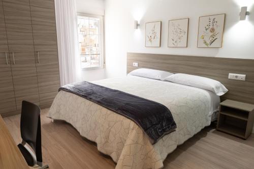 a bedroom with a large bed and a window at Rolix hc Hostal in Fuente-Álamo