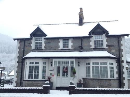 a house with snow on the roof at Oakfield House Bed and Breakfast in Betws-y-coed