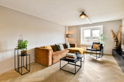 a living room with a couch and two tables at Bright City Retreat near Center & RAI in Amsterdam