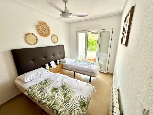 a bedroom with two beds and a window at Casa Sofinata with Pool View & Golf in Sucina