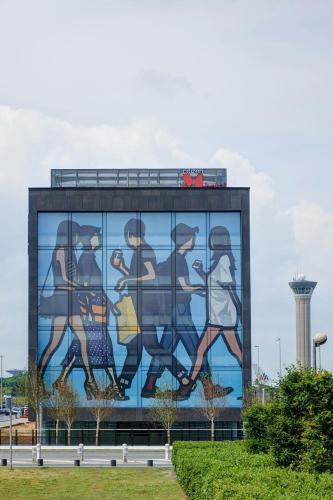 a mural on the side of a building at citizenM Paris Charles de Gaulle Airport in Roissy-en-France
