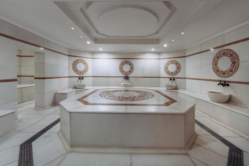 a bathroom with a large sink in a room at Paloma Perissia in Side