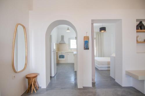 a white room with a hallway with a mirror at Ios Pearls-2 houses in Mylopotas