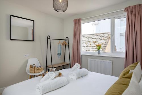 a bedroom with two beds and a window at The View in Sidmouth