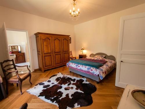 a bedroom with a bed and a rug on the floor at Château de Courcelles in Équevilley