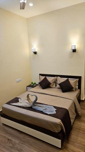 a bedroom with a large bed with a dress on it at Grace place in Vagamon