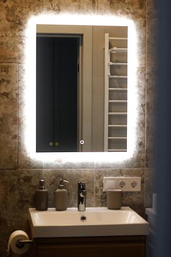 a bathroom with a sink and a mirror at Not A Hotel Cesis in Cēsis