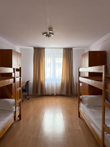 a room with three bunk beds and a window at ZipStay Inn in Cluj-Napoca