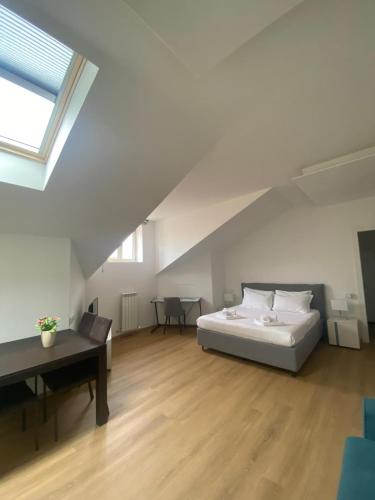 a bedroom with a bed and a desk in a attic at HOMEY I Palazzo Venezian Apartments in Trieste
