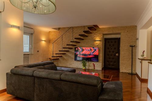 a living room with a couch and a staircase at La Mia Reggia B&B in San Nicola La Strada