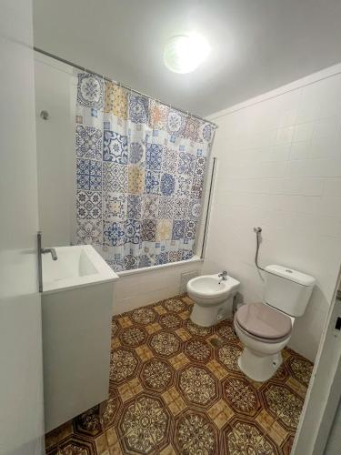 a bathroom with a toilet and a sink at 2BR Estoril Apartment - Near Estoril Beach & Cascais - Sleeps 4 in Estoril