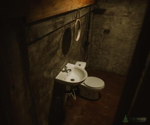 a bathroom with a sink and a toilet at Zen Marie Tanay in Sampong