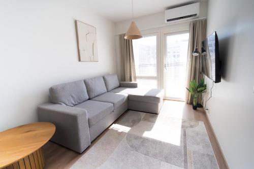 a living room with a couch and a table at Joutsen Apartments in Rovaniemi