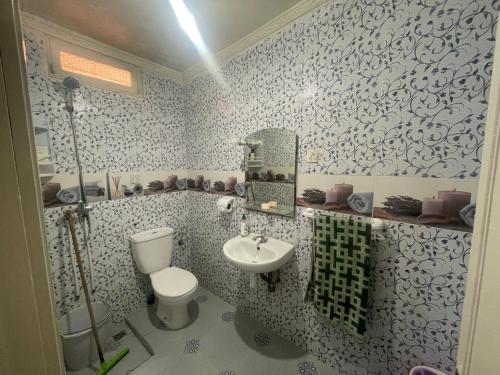 a bathroom with a toilet and a sink at Mavi Surf Stay Tamraght in Tamraght Ouzdar