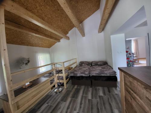 a bedroom with a bed and a wooden floor at Apartmán u kolejí C in Klobouky u Brna