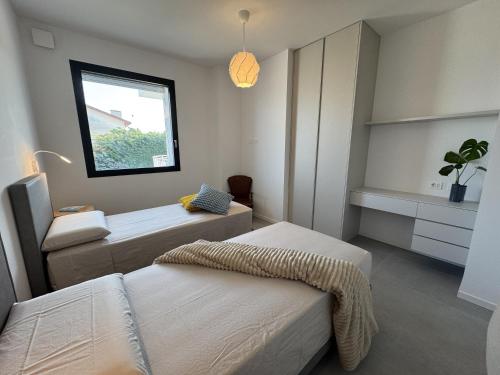 a bedroom with two beds and a window at Villa Admare - LUX - minipiscina Spa vista mare - Spiaggia inclusa in Numana