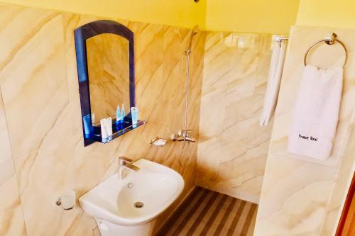 a bathroom with a sink and a toilet and a mirror at Premier motel in Bushenyi
