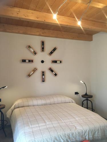 a clock on a wall with wine bottles on it at Agriturismo da Mamma in Alba