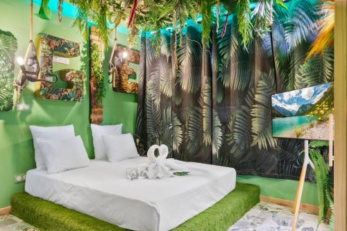 a bedroom with a white bed and a mural at YourSuite Studio Premium à Thème in Chaville