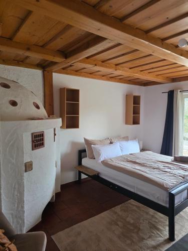 a bedroom with a bed in a room with wooden ceilings at GreenHell Stays Müsch - Nürburgring in Müsch