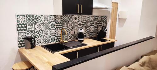 a kitchen with a counter with a laptop on it at Studio à 5 minutes des Musées in Grasse