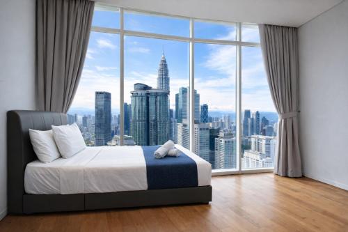 a bedroom with a large window with a city view at KL Suites Apartment At Vortex in Kuala Lumpur