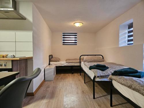 a room with two beds and a kitchen at Apartment in Vaihingen an der Enz - Ensingen in Vaihingen an der Enz
