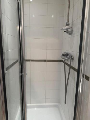 a bathroom with a shower with a glass door at Cosy House in Reading