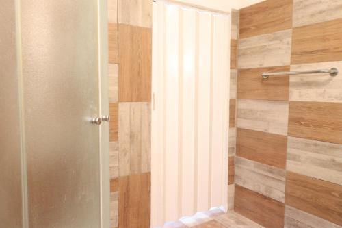 a shower with a glass door in a bathroom at Holiday Home Desire in Kras