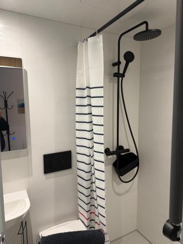 a bathroom with a shower and a toilet and a sink at 70 Bath Street in Saint Helier Jersey