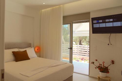 a bedroom with a bed and a sliding glass door at SUMU Luxury Apartment in Lefkada
