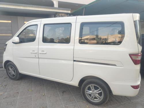 a white van parked next to a building at Guest Pick-Up & Drop-Off Service in Karachi