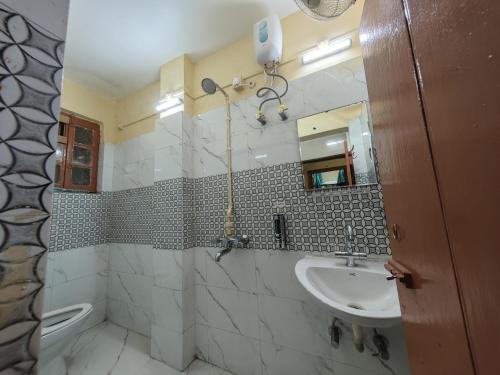 a bathroom with a sink and a mirror at Evara Stays Backpackers Hostel in Kolkata