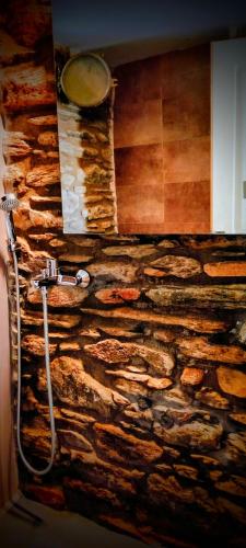 a stone wall with a shower in a bathroom at AegeanDeepBlue2 in Apróvaton