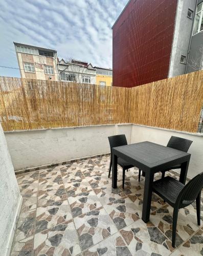 a patio with two chairs and a table on a balcony at Skymoon Istanbul Airport Hotel in Arnavutköy