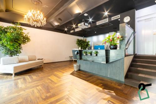 a lobby with a couch and potted plants at Hotiday Milano Risorgimento in Milan