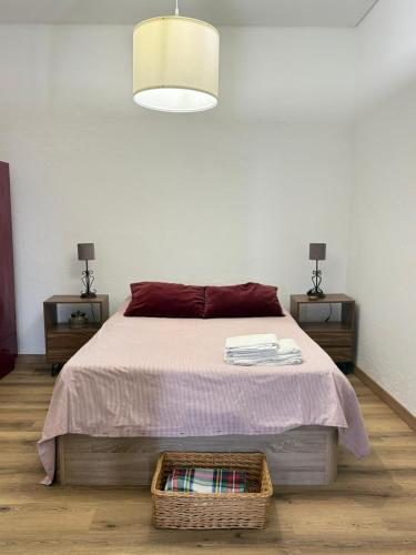a bedroom with a bed and two night stands with lamps at Casa & Caminho AL in Velas