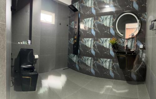 a bathroom with a toilet and a mirror at The calm villa in Kandana