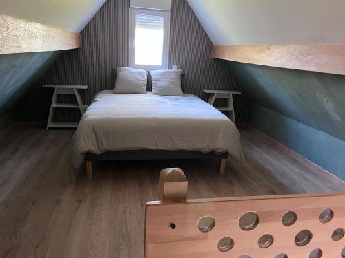 a bedroom with a bed and two tables and a window at Fully equipped, independent apartment in Marles-en-Brie