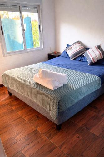 a bedroom with a bed with a towel on it at Renacer in Piriápolis