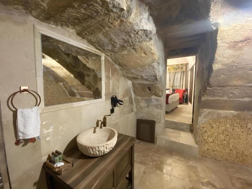 a bathroom with a sink and a stone wall at Sevdalı Konakları in Avanos