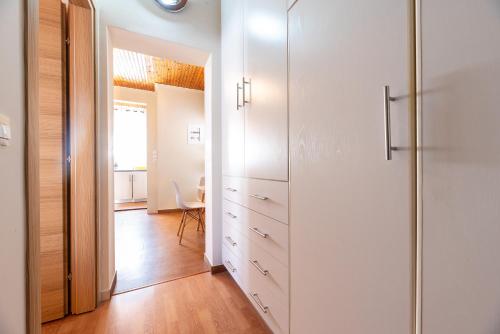 a kitchen with white cabinets and a hallway at Dream Houses Near Athens Airport By SEM in Artemida
