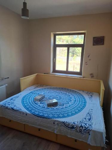 a large bed in a bedroom with a window at Balto kalno namai, Kernavėje in Kernavė